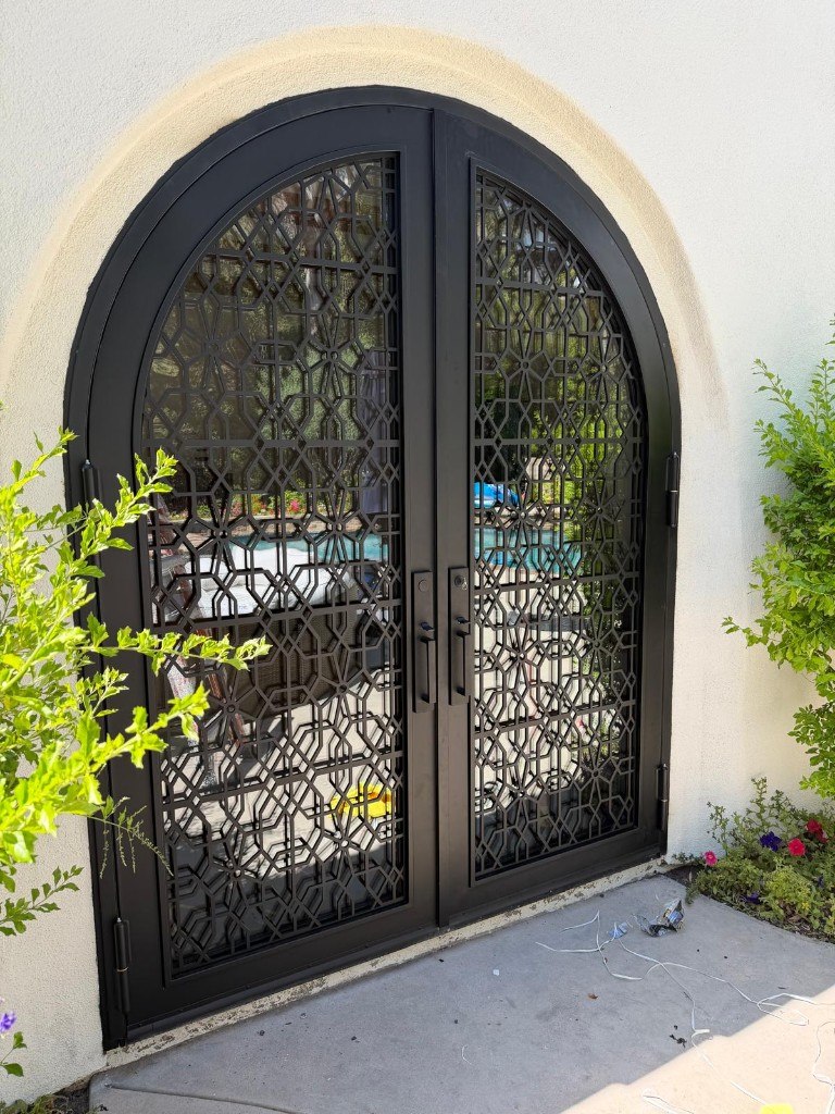 Custom arched steel doors with geometric lattice