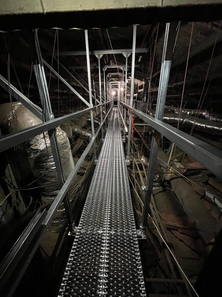 Long galvanized catwalk through a commercial attic and ductwork