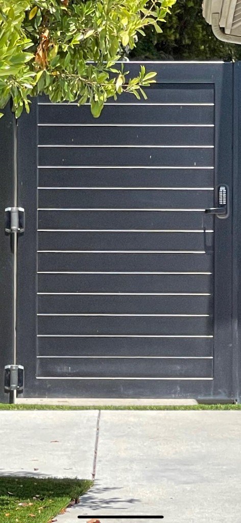 Modern black iron pedestrian gate with horizontal slats