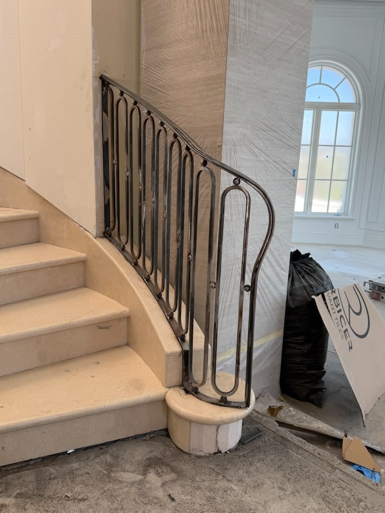 Custom iron stair railing with oval loop balusters
