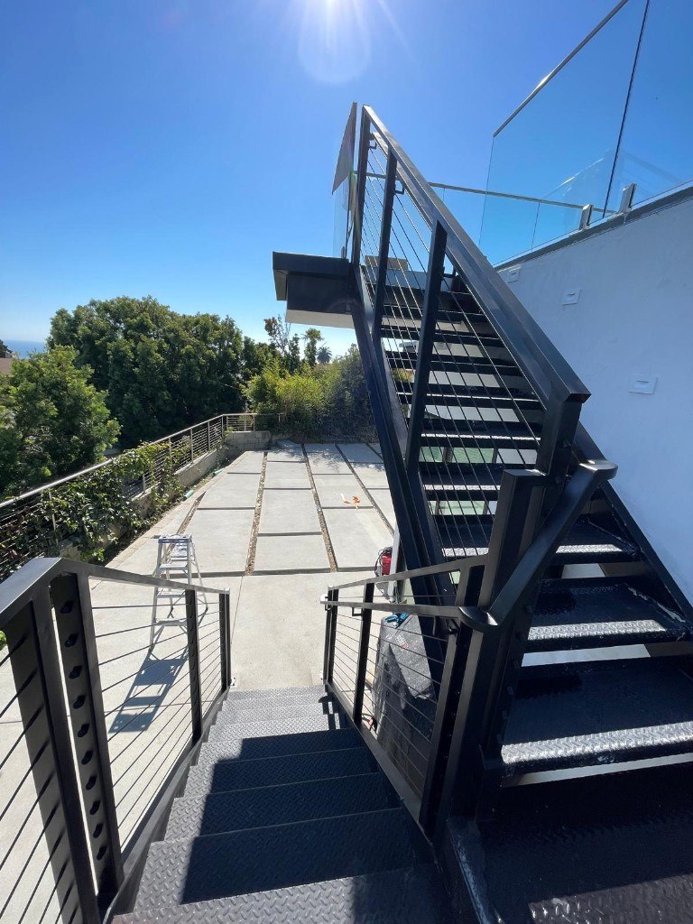Black steel staircase with cable guard rails